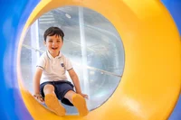 Child smiling in the slide