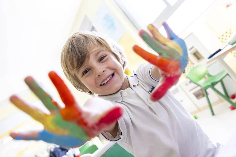 Child showing coloured hands