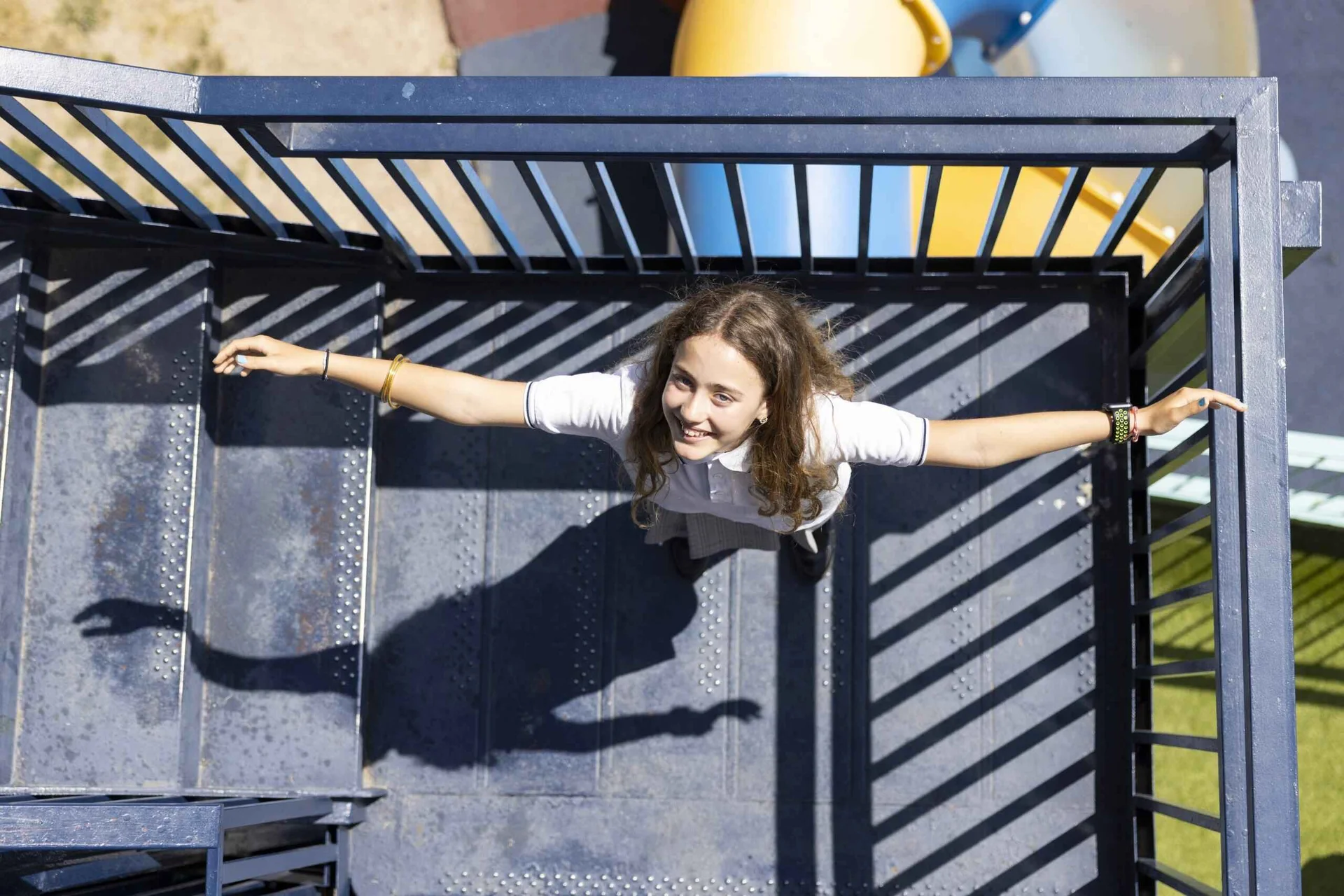 Girl on the stairs with open arms