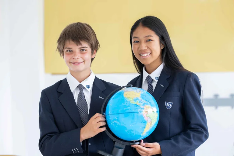 students hold a globe