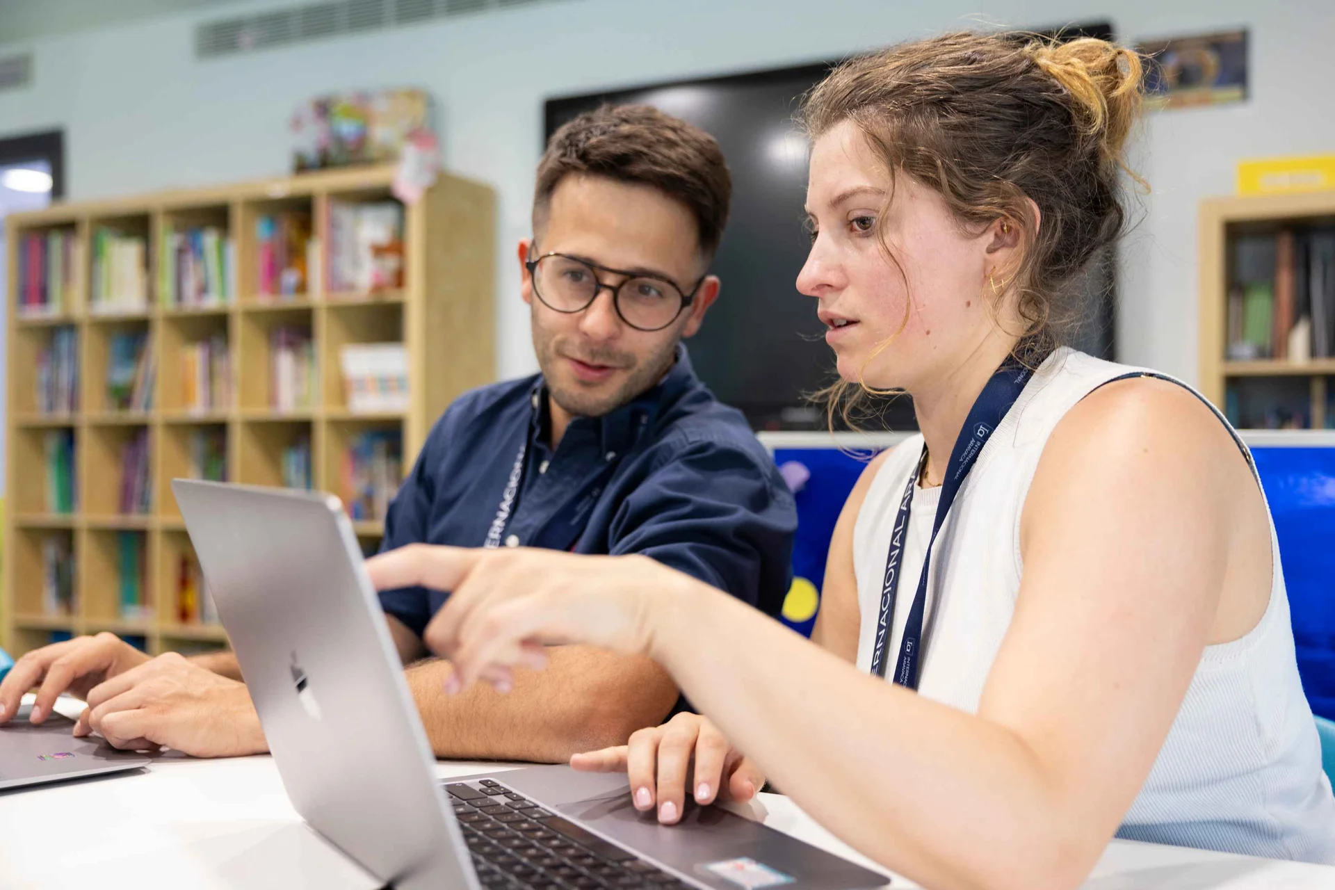 Teachers looking at the screen of a computer