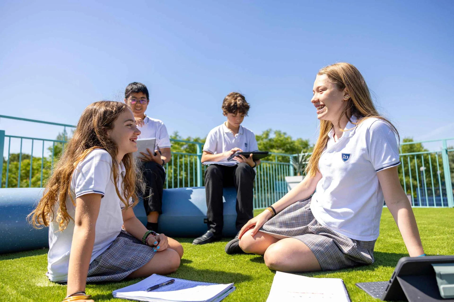 Four students studying in the schoolyard
