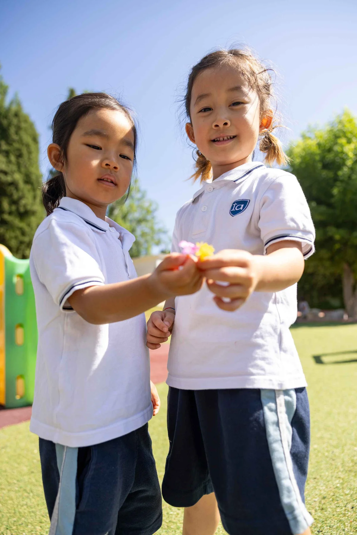 Children holding flowers in the schoolyard