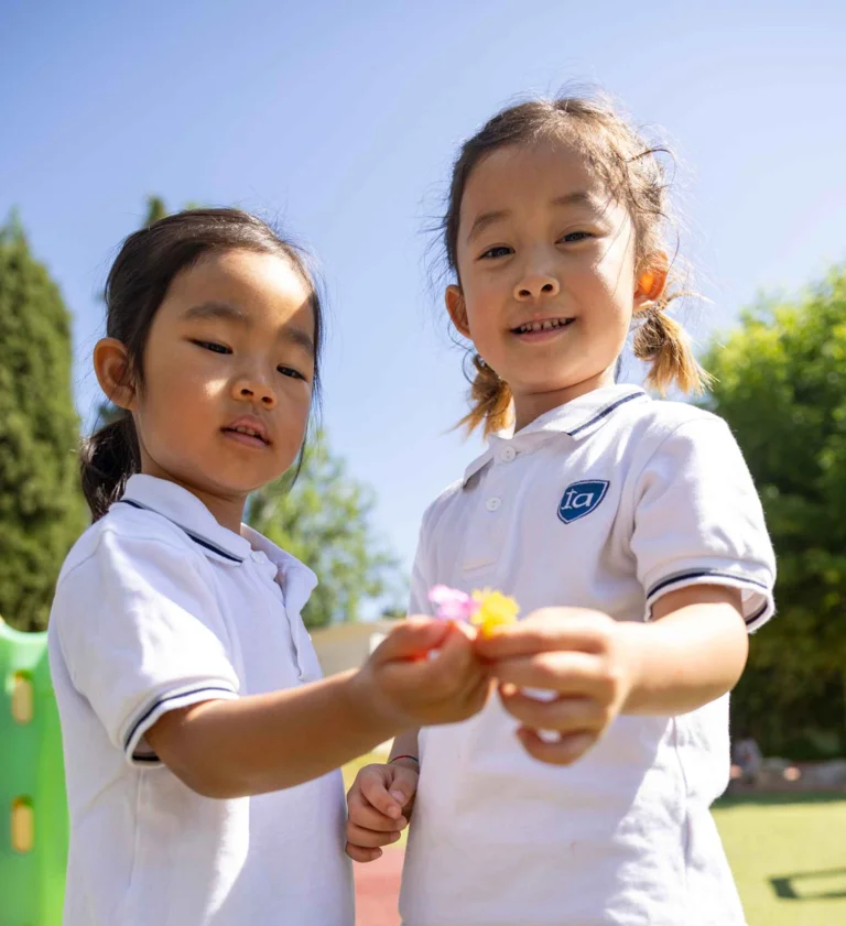 Children holding flowers in the schoolyard