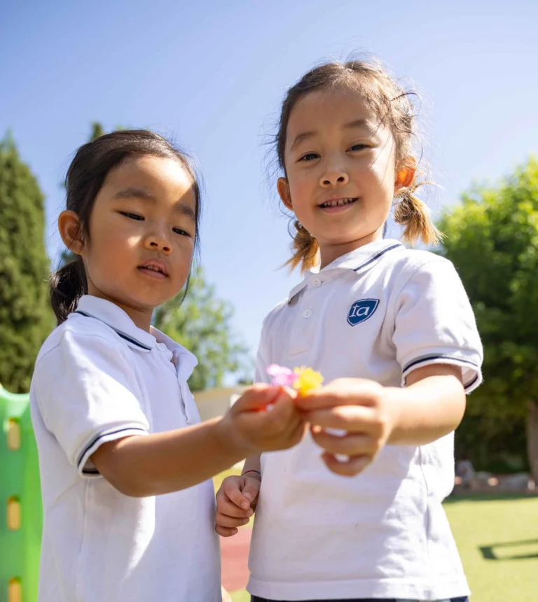 Children holding flowers in the schoolyard