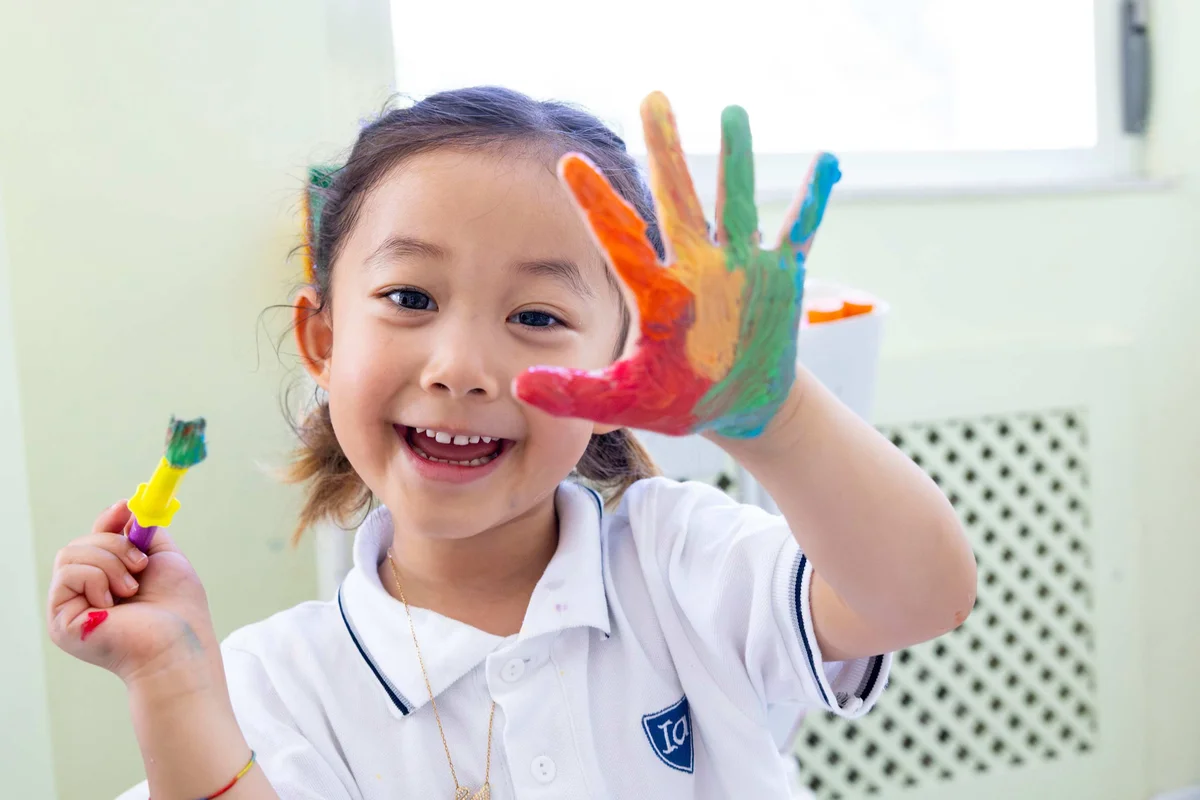 Pre school child showing painted hand