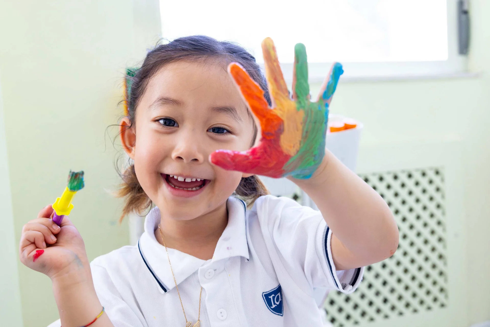 Pre school child showing painted hand