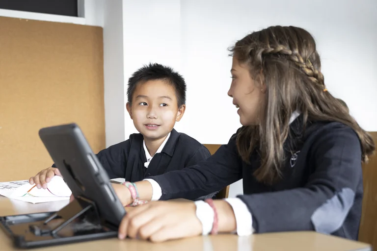 Students with the tablet looking each other