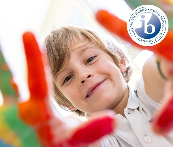 Early years child showing coloured hands